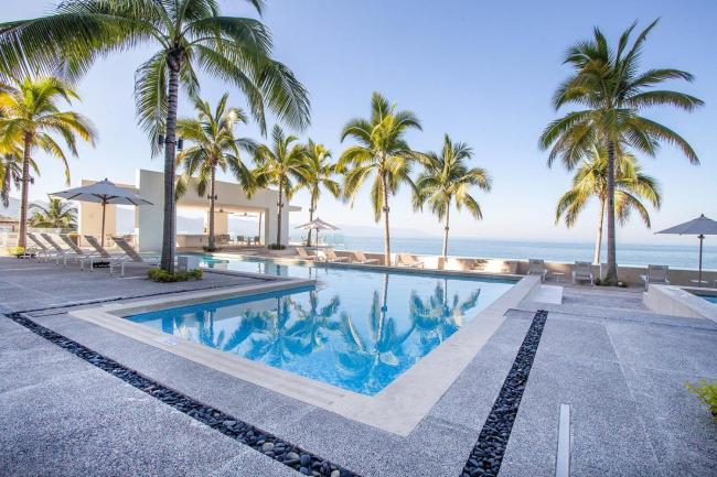Upscale Corner Unit with Large Wrap Around Balcony and Pools Images_1